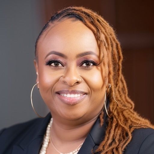 Person with long, braided hair wearing a dark blazer and hoop earrings.